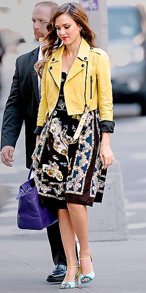 Jessica Alba added an extra pop of color to her Dolce and Gabbana dress with a yellow Burberry leather jacket