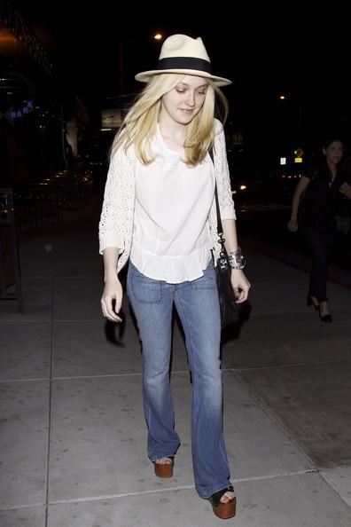 Dakota Fanning adds a boho chic touch to her fedora with wide leg jeans, a flowing white blouse and wooden wedge heels