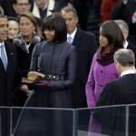 President Obama's family looks on as he is sworn into office by Chief Justice John G. Roberts