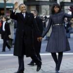 The Obamas greet the crowds at a parade following the inauguration ceremony