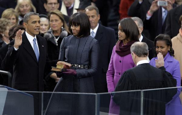 President Obama's family looks on as he is sworn into office by Chief Justice John G. Roberts 