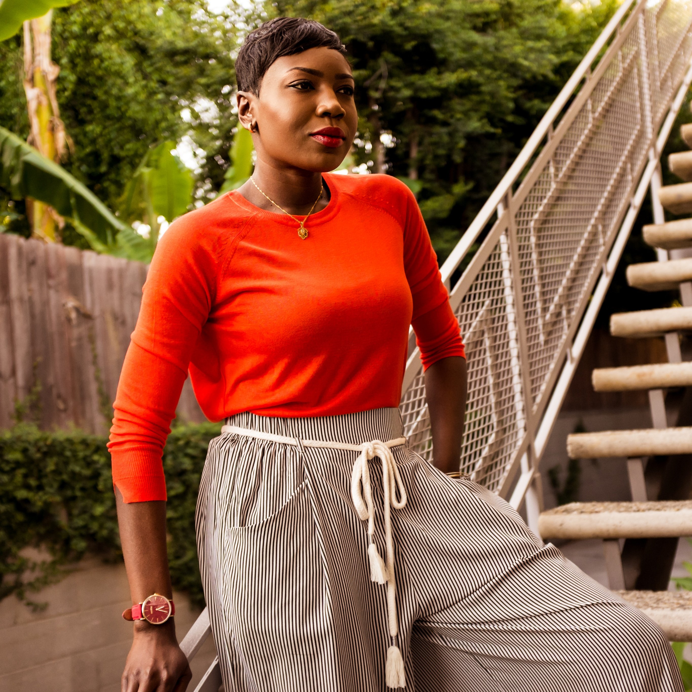 Spring and summer are the perfect times to go bold in gorgeous color. The SoHo adds some extra sizzle to this lightweight tangerine sweater and striped pants from Zara.
