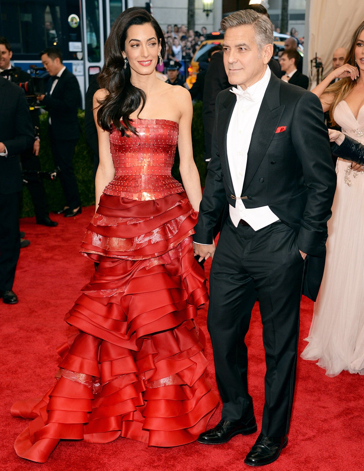 Amal Clooney in a red custom Maison Margiela Artisanal by John Galliano corset top and tiered skirt.